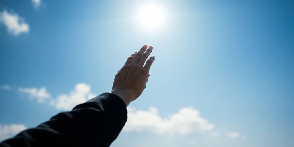 Person reaching for a bright, shining star in a vast, open sky.